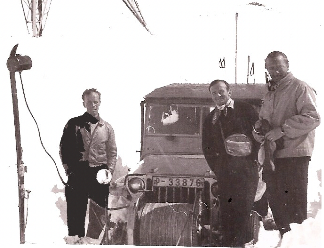 Black and white image of men and a vintage rope tow